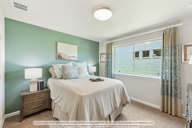 bedroom featuring baseboards, visible vents, and light colored carpet