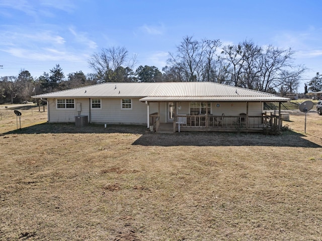 back of property featuring covered porch, metal roof, and central AC