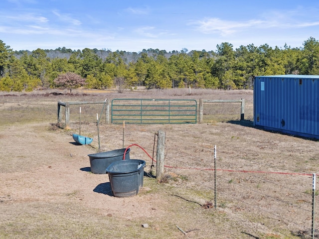 view of yard with a rural view and fence