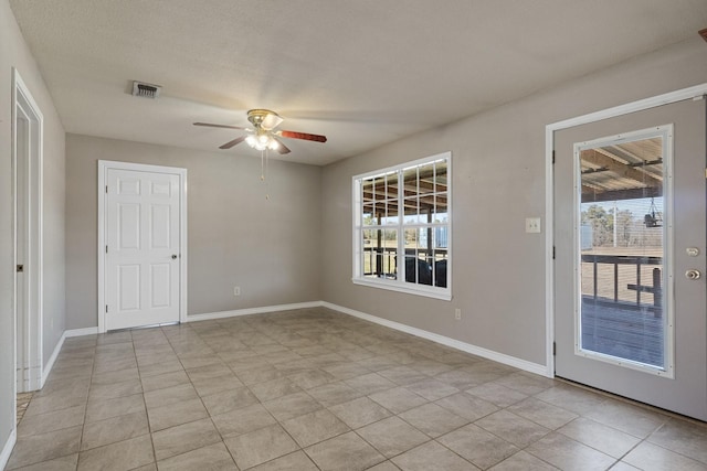 unfurnished room with visible vents, ceiling fan, baseboards, and light tile patterned flooring