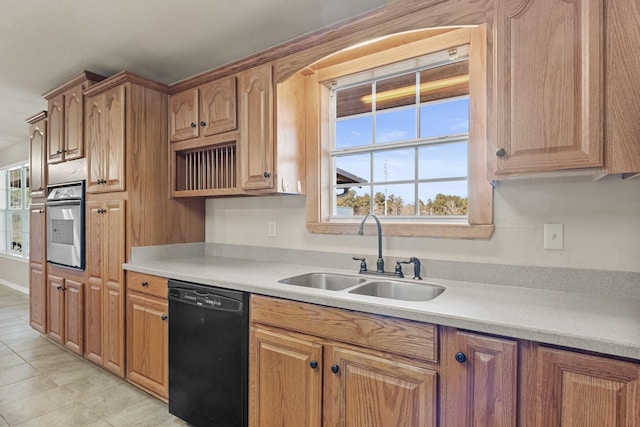 kitchen featuring open shelves, light countertops, a sink, oven, and dishwasher