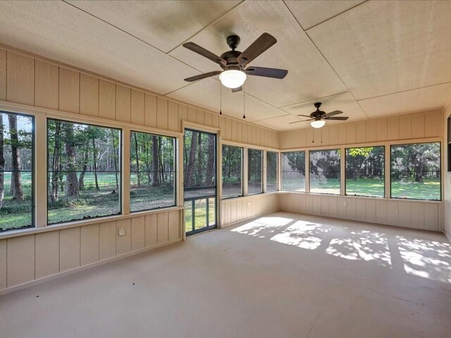 unfurnished sunroom with ceiling fan