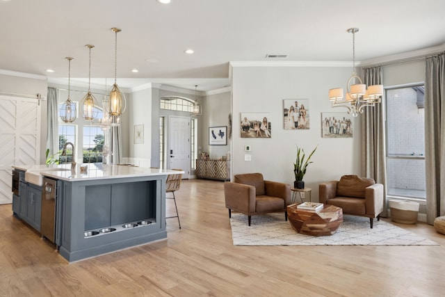 kitchen with a chandelier, visible vents, open floor plan, light countertops, and light wood finished floors