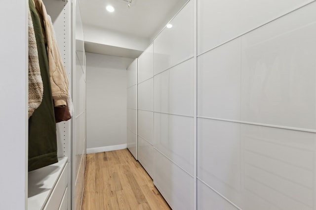 walk in closet with light wood-type flooring