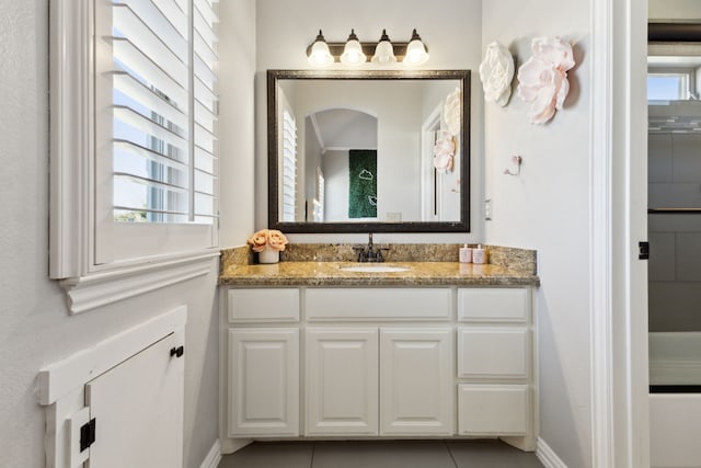 bathroom featuring tile patterned flooring, vanity, and baseboards