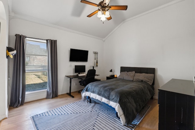 bedroom with lofted ceiling, baseboards, wood finished floors, and crown molding