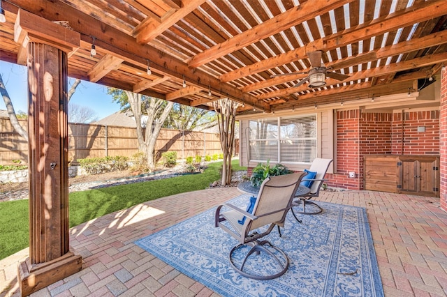 view of patio / terrace featuring ceiling fan, fence, and a pergola