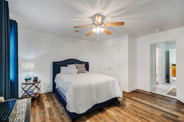 bedroom featuring ceiling fan, wood finished floors, visible vents, and baseboards