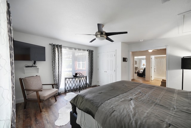 bedroom featuring attic access, a closet, ceiling fan, and wood finished floors