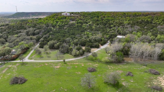 birds eye view of property featuring a wooded view