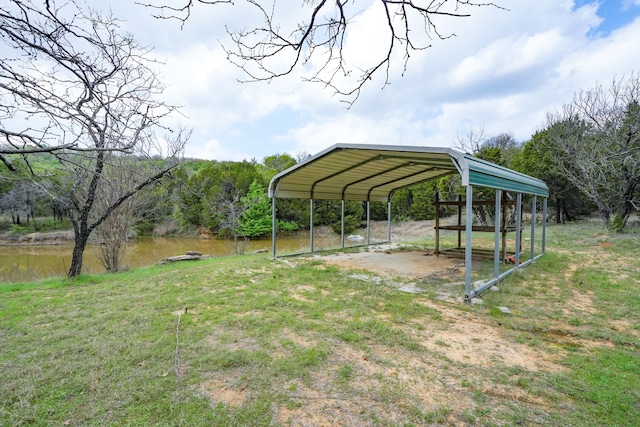 view of yard with driveway and a carport