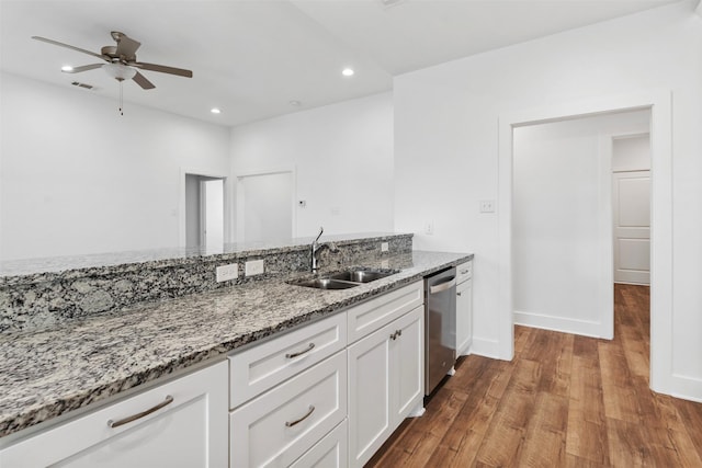 kitchen featuring wood finished floors, a sink, light stone countertops, white cabinetry, and stainless steel dishwasher