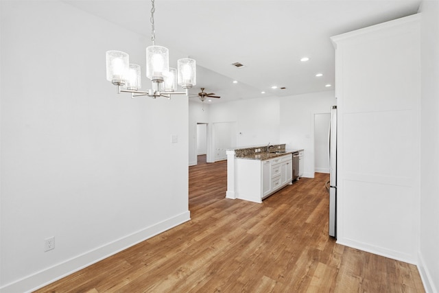 kitchen featuring visible vents, baseboards, light wood-style flooring, appliances with stainless steel finishes, and white cabinetry