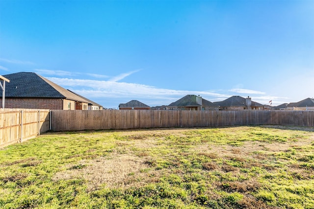 view of yard with a fenced backyard