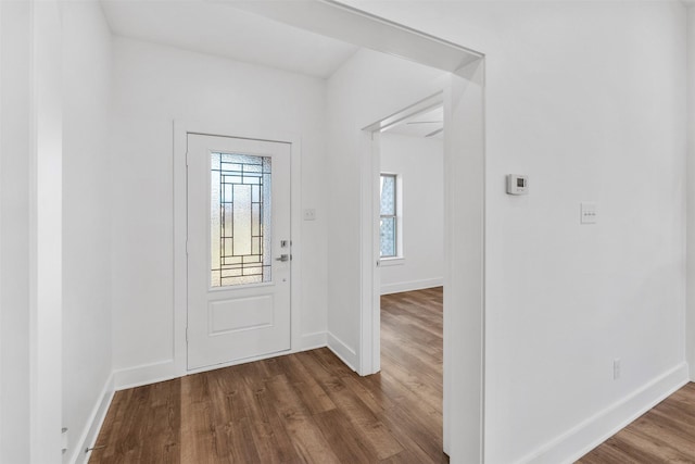 entryway featuring dark wood-style flooring and baseboards