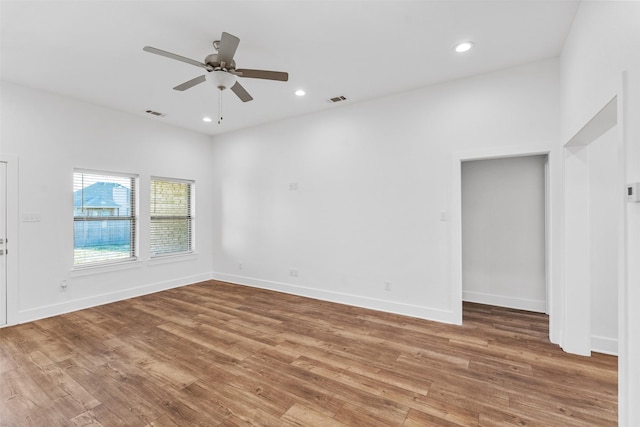 unfurnished room featuring recessed lighting, baseboards, and wood finished floors