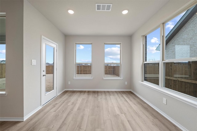 unfurnished sunroom with visible vents