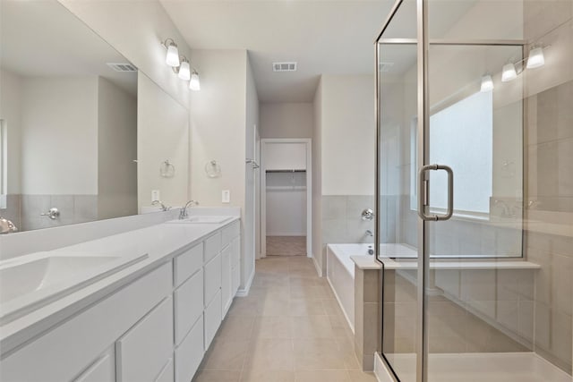 bathroom featuring a stall shower, visible vents, and a sink