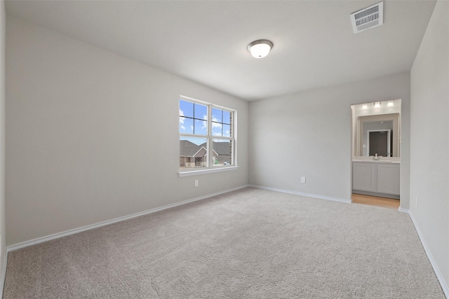 unfurnished room with baseboards, visible vents, and carpet flooring