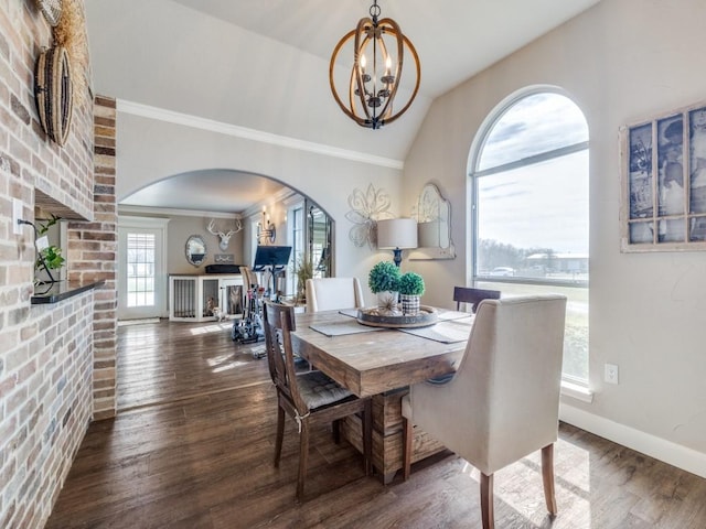 dining area with an inviting chandelier, baseboards, arched walkways, and wood finished floors