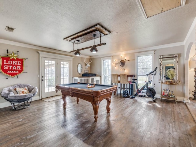 game room featuring wood finished floors, visible vents, and a healthy amount of sunlight