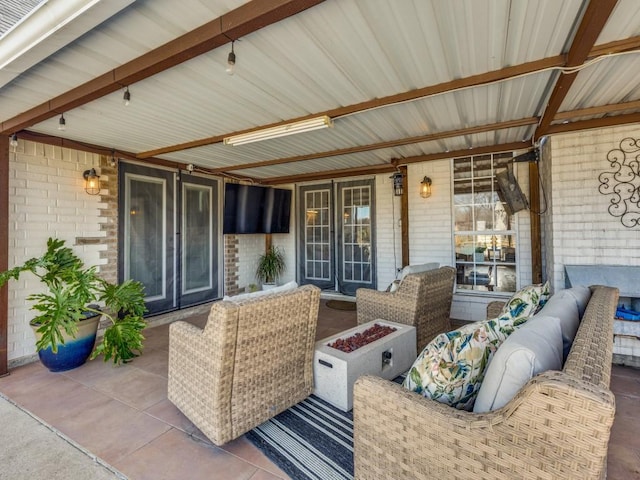 view of patio / terrace with an outdoor living space with a fire pit