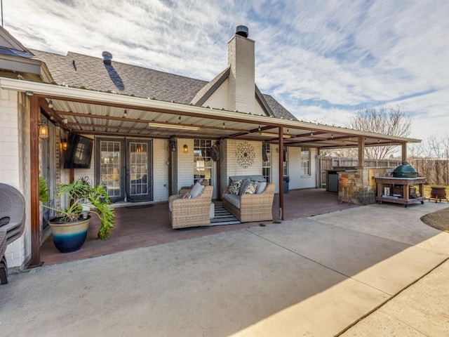 rear view of property with french doors, roof with shingles, a patio, and a chimney