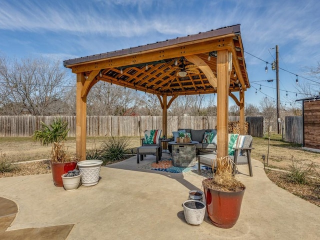 view of patio with ceiling fan, a fenced backyard, outdoor lounge area, and a gazebo