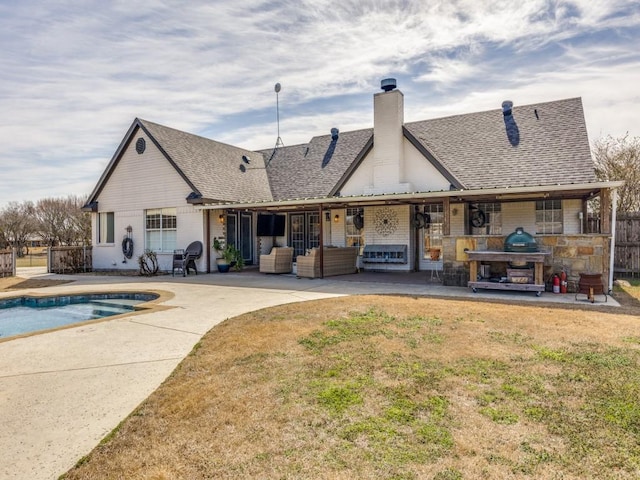 rear view of property with a patio, a chimney, roof with shingles, fence, and an outdoor living space