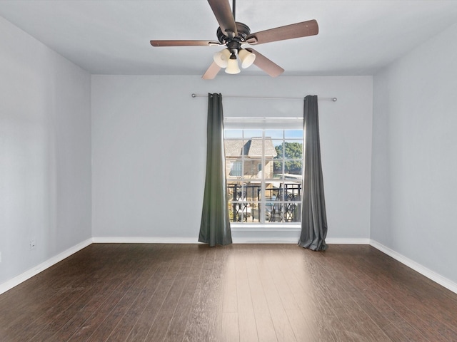 empty room with ceiling fan, baseboards, and wood finished floors