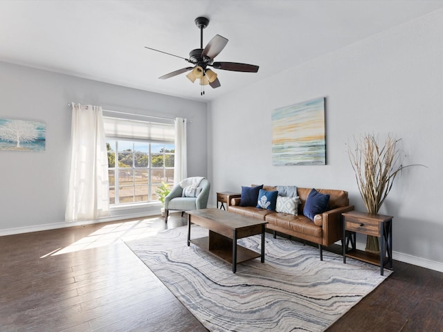 living room featuring baseboards, ceiling fan, and hardwood / wood-style floors