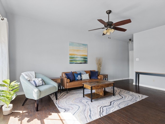 living area featuring ceiling fan, baseboards, and wood finished floors