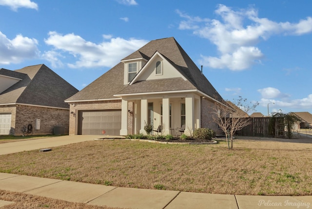 view of front of house featuring a garage, a front yard, concrete driveway, and brick siding