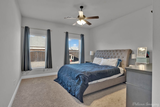 carpeted bedroom with baseboards and a ceiling fan