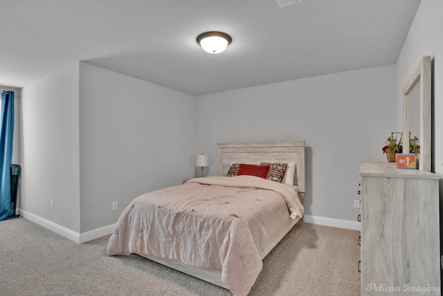 bedroom with carpet floors and baseboards