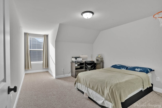 carpeted bedroom with lofted ceiling and baseboards