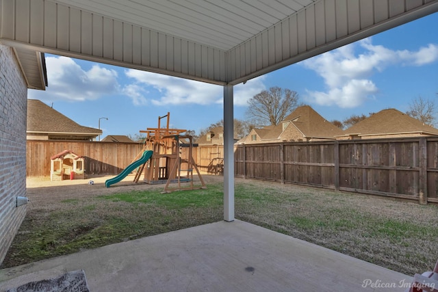 view of play area featuring a patio area, a fenced backyard, and a lawn