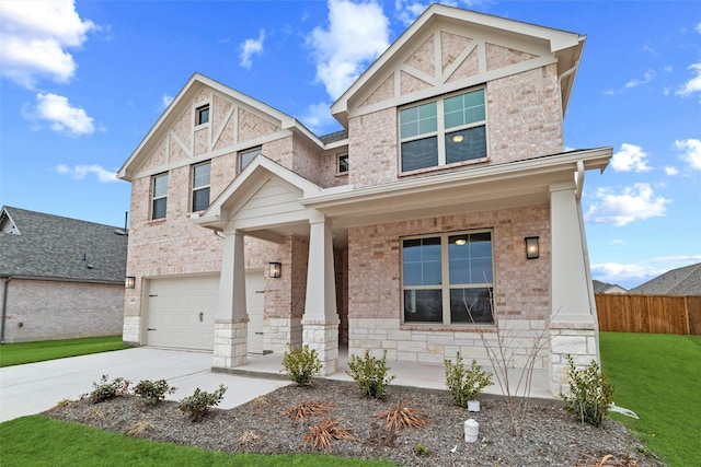 view of front of house with brick siding, concrete driveway, an attached garage, a porch, and a front yard