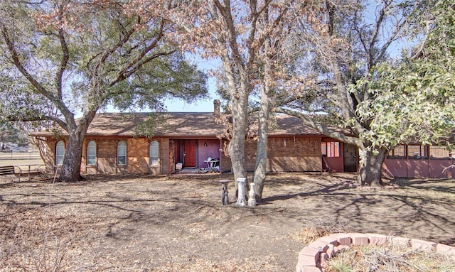 ranch-style home with fence