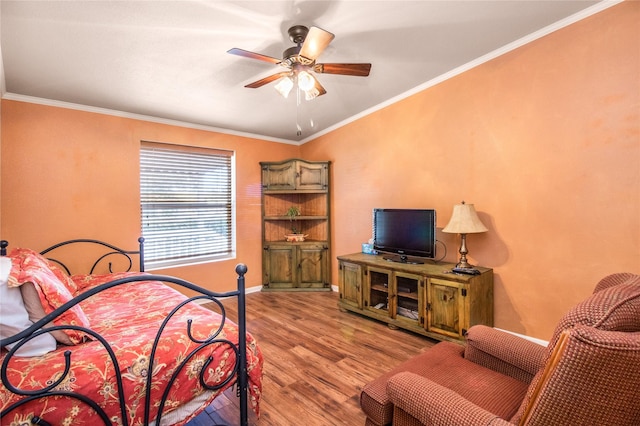 bedroom featuring ornamental molding, light wood finished floors, a ceiling fan, and baseboards