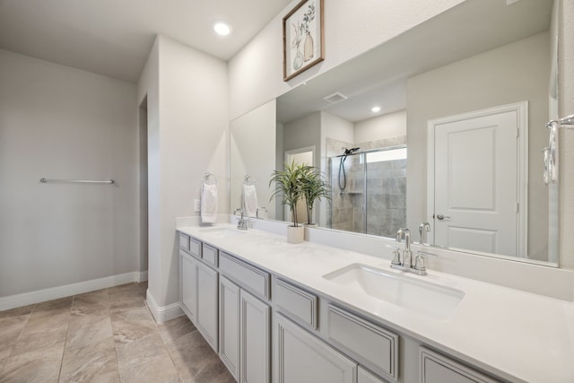 full bathroom featuring baseboards, a shower stall, visible vents, and a sink