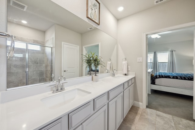 full bath featuring a shower stall, connected bathroom, visible vents, and a sink