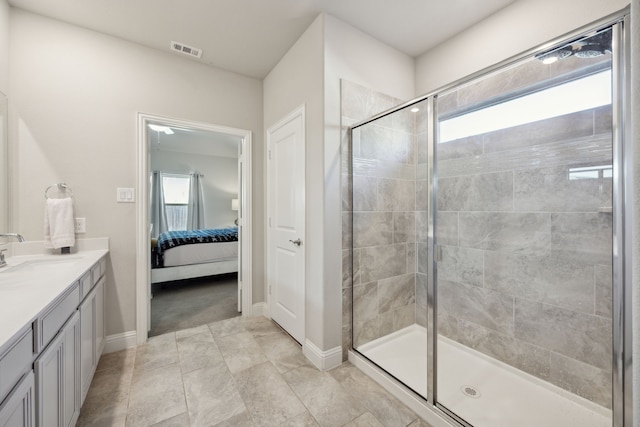 bathroom with a stall shower, baseboards, visible vents, connected bathroom, and vanity