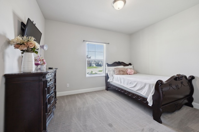 carpeted bedroom featuring baseboards