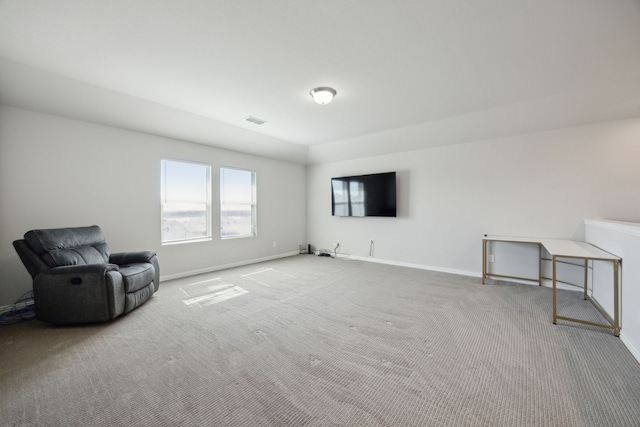 living area with carpet, visible vents, and baseboards