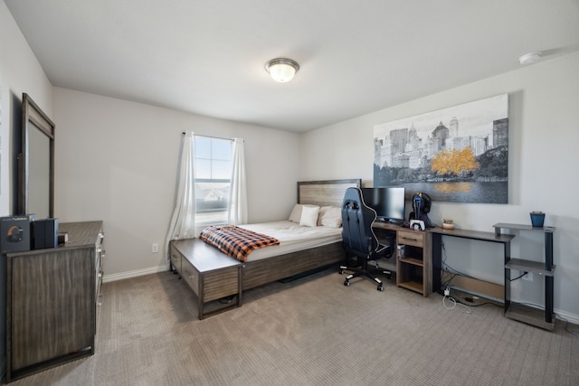 bedroom featuring baseboards and light colored carpet