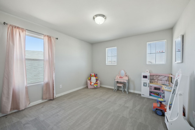 recreation room featuring carpet flooring and baseboards