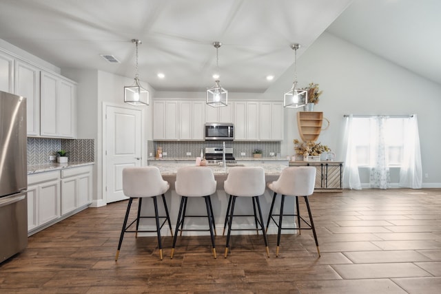 kitchen featuring dark wood-type flooring, a sink, visible vents, white cabinetry, and appliances with stainless steel finishes