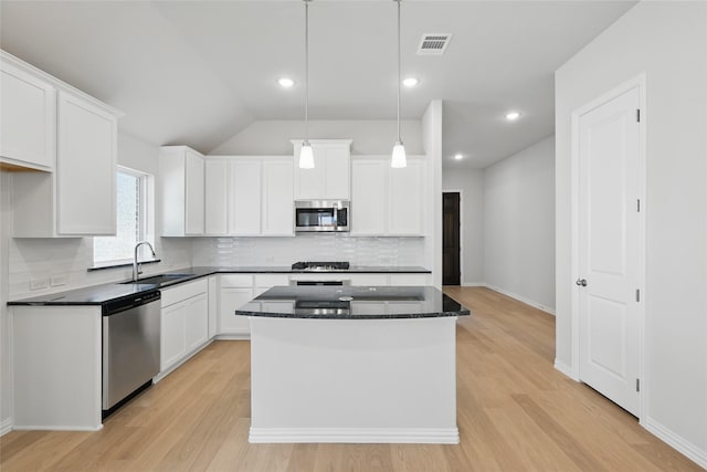 kitchen featuring a sink, visible vents, decorative backsplash, white cabinets, and appliances with stainless steel finishes