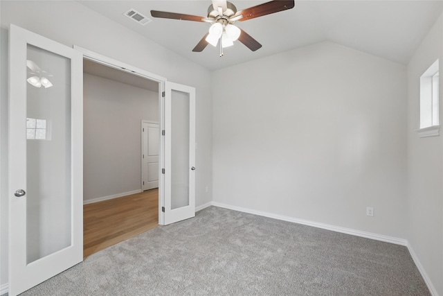 empty room featuring ceiling fan, carpet flooring, baseboards, and visible vents